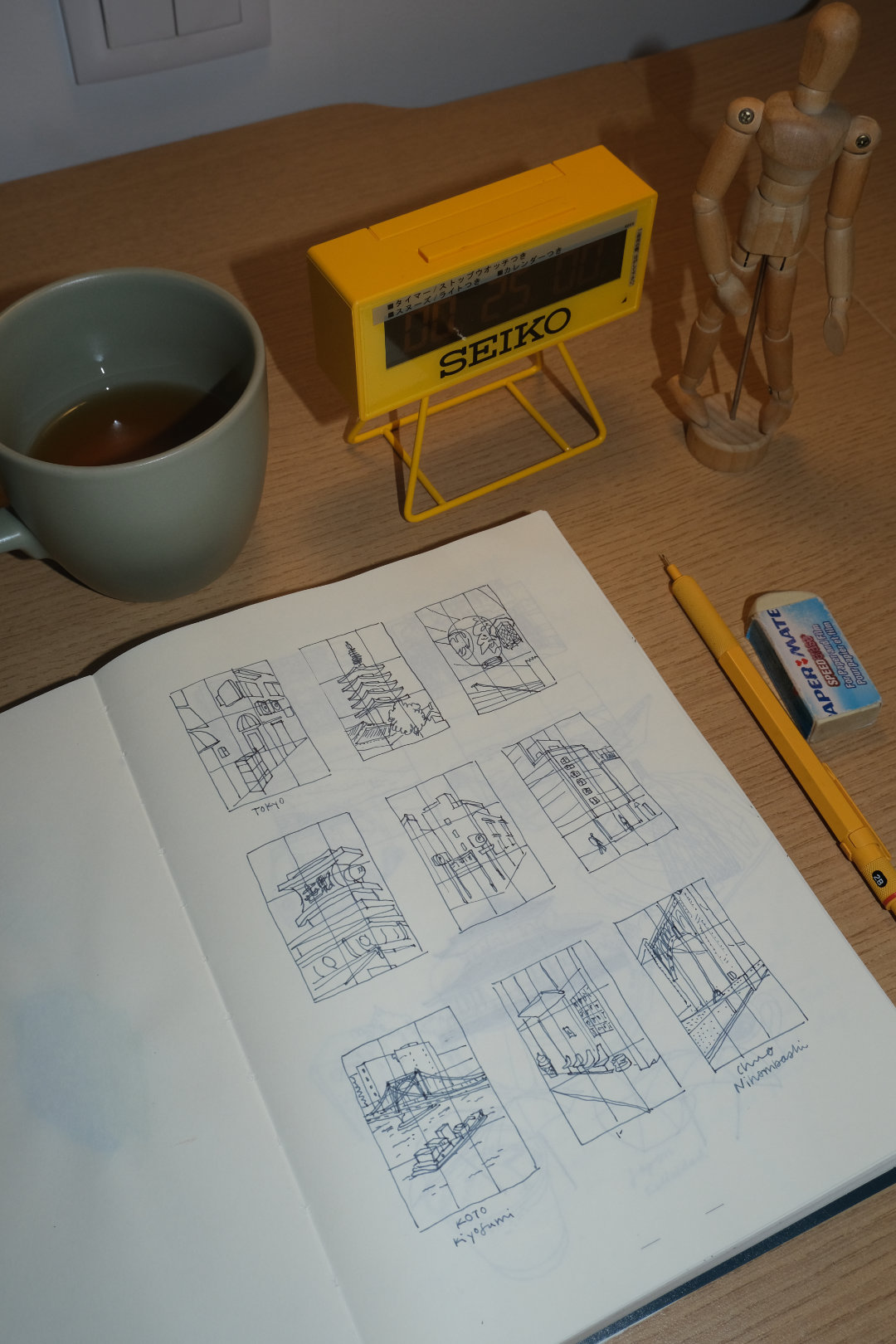 Hands holding an open sketchbook